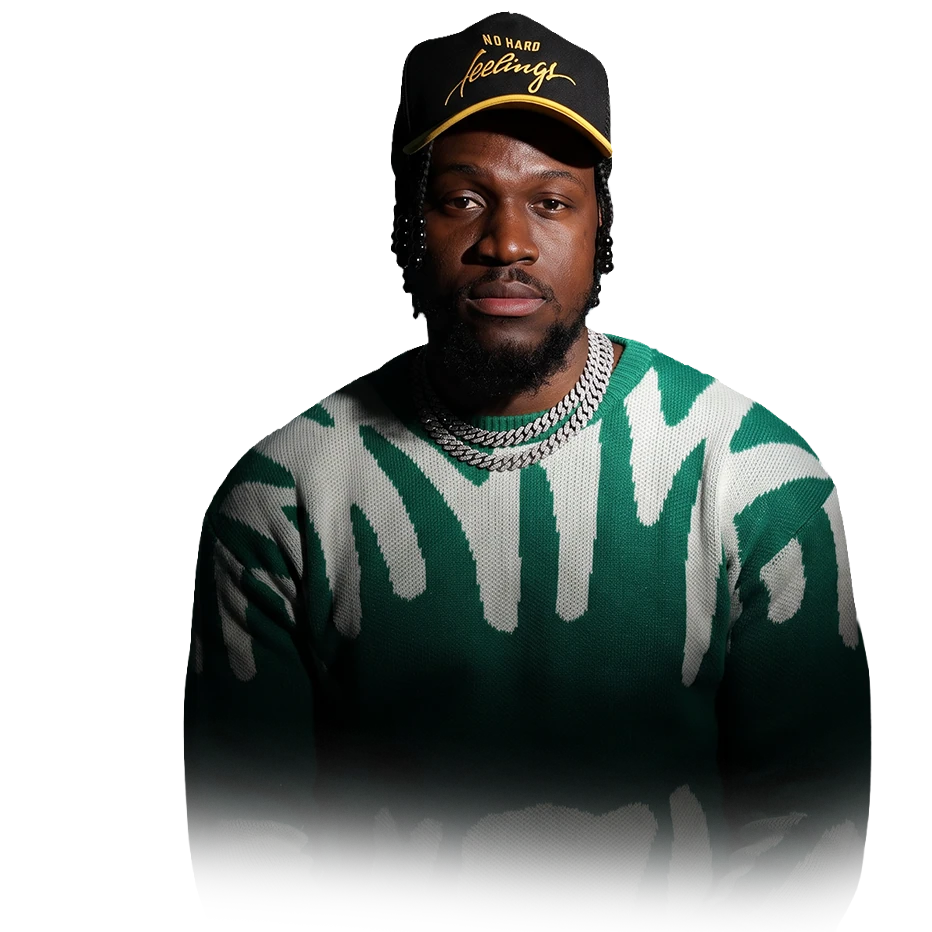 Givenchy of LEGAL MEN BAGAY in a black cap and a green and white knit sweater